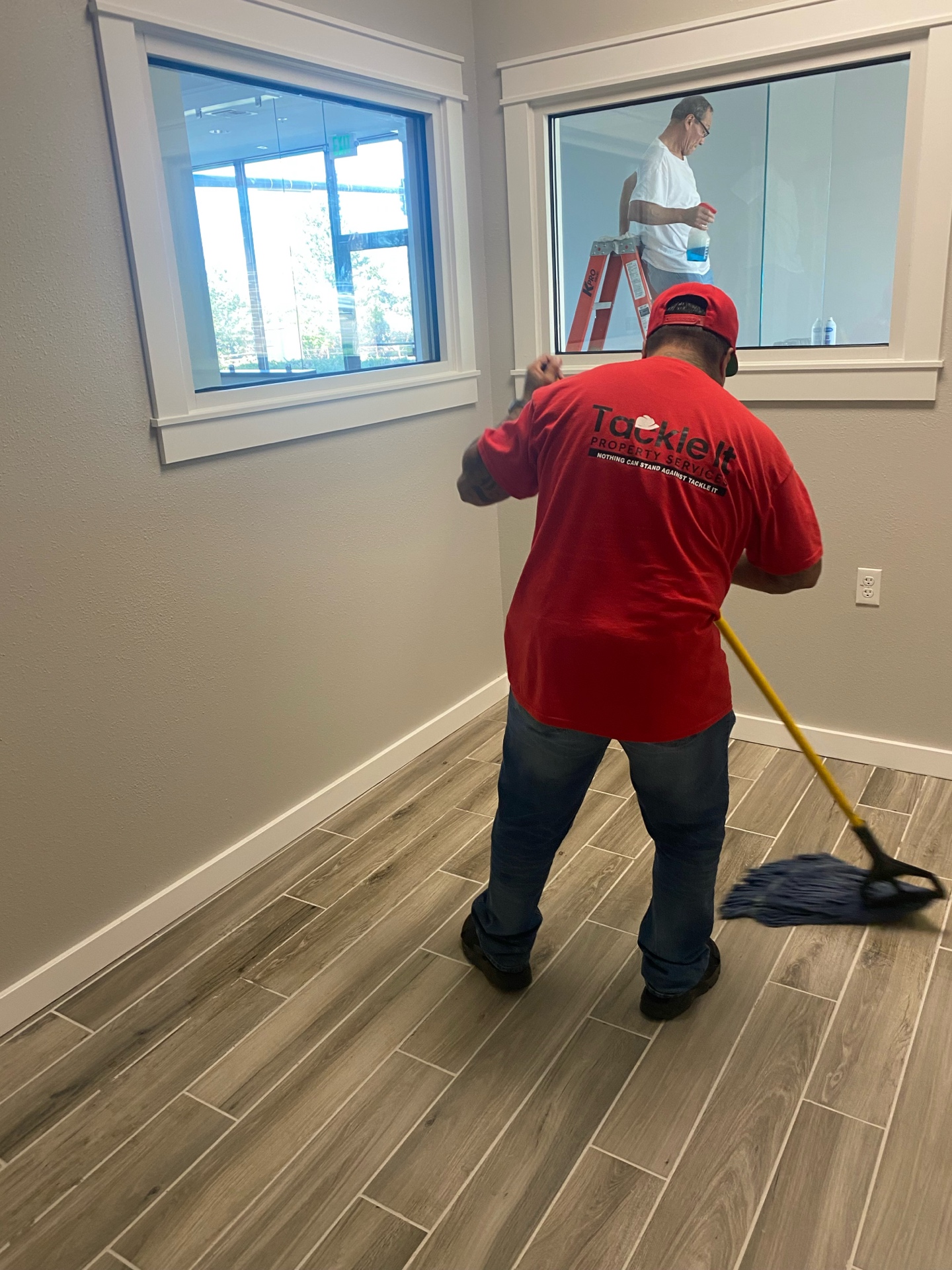 Tackle It team member in red shirt cleaning